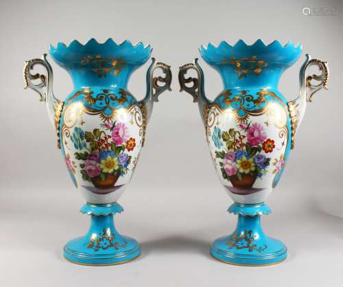 A PAIR OF SEVRES STYLE PORCELAIN TWIN-HANDLED PEDESTAL VASES, pale blue ground, decorated with