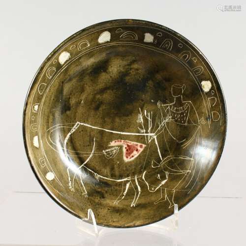 A MID 20TH CENTURY STUDIO POTTERY DISH, decorated with a bull fighting scene, signed and inscribed