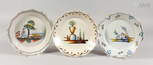 THREE 18TH CENTURY CONTINENTAL FAIENCE PLATES, with polychrome decoration, two depicting cherubs and