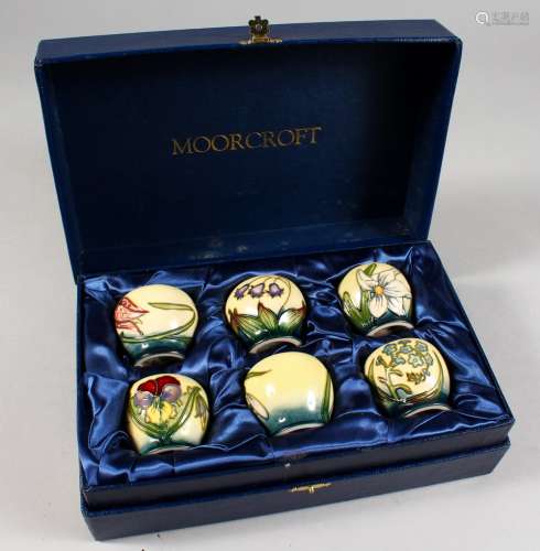 A SET OF SIX W. MOORCROFT EGG CUPS 2001, 1.75ins high, in a fitted Moorcroft blue box. Cost