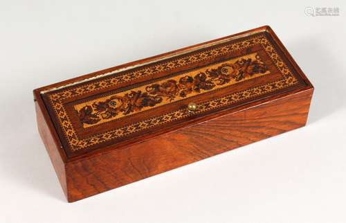 A LONG TUNBRIDGE WARE MARQUETRY AND PARQUETRY BOX, the lift-off lid inlaid with roses. 10ins long.