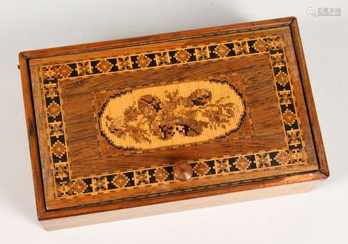 A TUNBRIDGE WARE MARQUETRY AND PARQUETRY BOX, the hinged lid inlaid with roses. 6.25ins long.