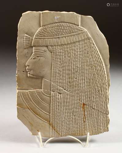 A SMALL LIMESTONE PANEL, carved with a female Egyptian bust. 9ins x 6.5ins.