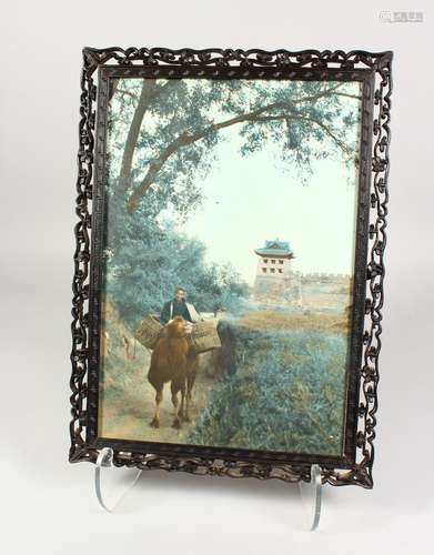 A CHINESE CARVED AND PIERCED FRAME, containing a photographic print. Frame: 17ins x 12ins.