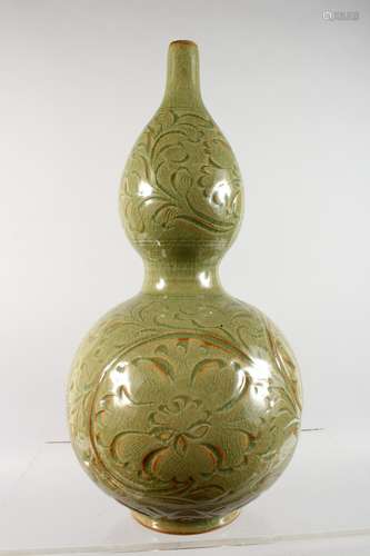 A CHINESE GREEN CELADON DOUBLE GOURD VASE, with incised decoration. 13ins high.