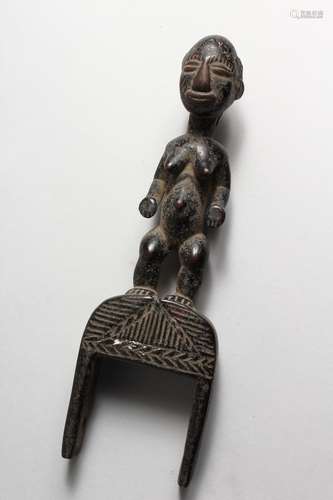 A CARVED WOOD FIGURAL TRIBAL PULLEY. 10ins high.