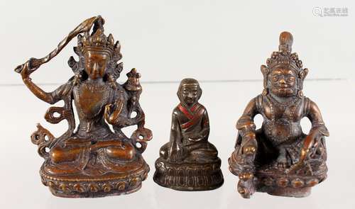 THREE SMALL BRONZE FIGURES OF SEATED BUDDHAS. 3ins high and smaller.