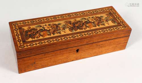 A TUNBRIDGE WARE LONG BOX, the hinged lid inlaid with roses and parquetry. 9.25ins long x 3.25ins