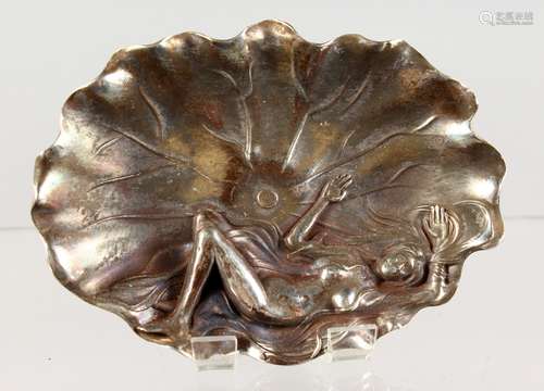 A CHINESE WHITE METAL LEAF SHAPED DISH, modelled as a naked woman on a lily pad. 5ins wide.