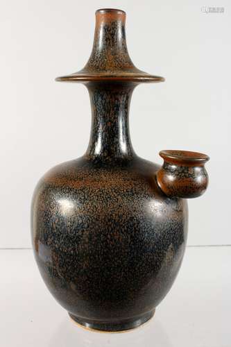 AN UNUSUAL CHINESE BROWN GLAZED EARTHENWARE BOTTLE VASE. 8.5ins high.