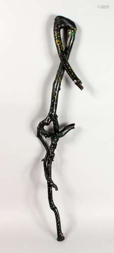 A FOLK ART WALKING STICK, carved as entwined snakes. 37ins long.