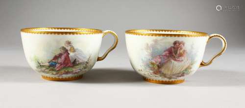 A FINE PAIR OF SEVRES BREAKFAST CUPS, each beautifully painted on each side with a courting