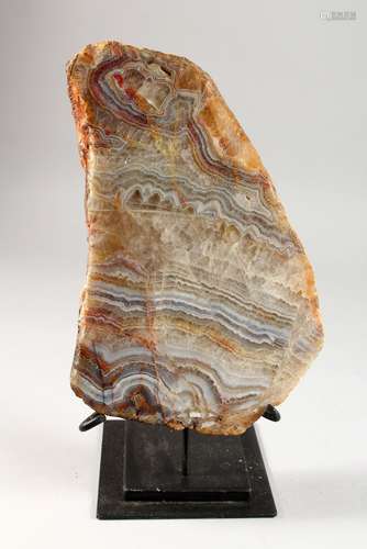 A LARGE AGATE SPECIMEN, mounted on a stand. Agate: 11ins high.