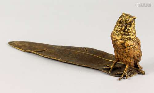 A VIENNA STYLE COLD PAINTED BRONZE, of a wise owl inkwell, standing on a feather. 13ins long.