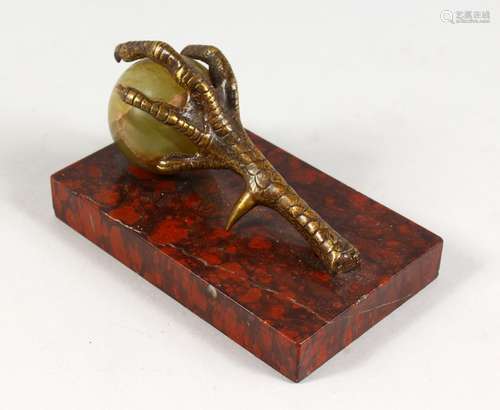 A BRONZE, ONYX AND ROUGE MARBLE PAPERWEIGHT, modelled as a claw and ball. 5.25ins long.