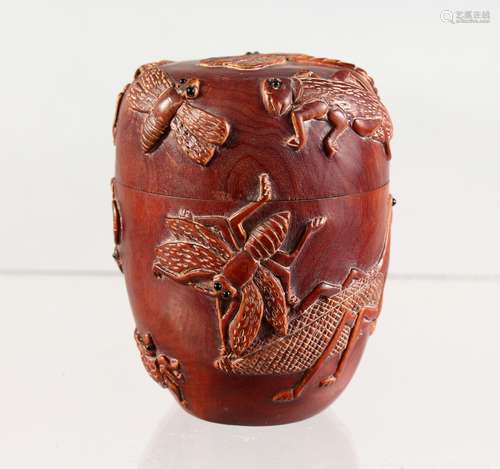 A JAPANESE WOODEN BOX AND COVER, carved with insects. 3ins high.