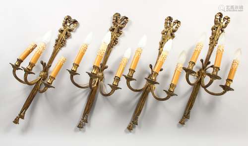 A SET OF FOUR CLASSICAL STYLE ORMOLU RIBBON AND BOW THREE LIGHT WALL APPLIQUES. 2ft 0ins high.