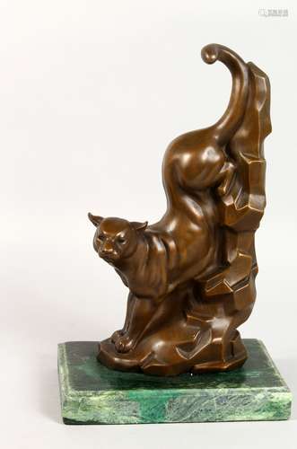 AN ART DECO STYLE BRONZE MODEL OF A PANTHER, descending a mountain, on a marble base. 13.5ins high.