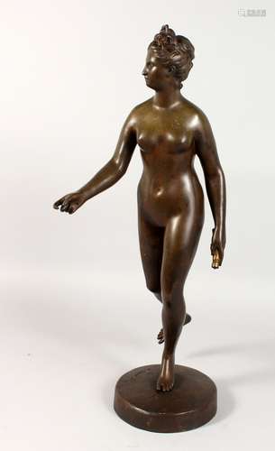 A CLASSICAL STYLE BRONZE STANDING FEMALE NUDE. Signed Houdon. 24ins high.