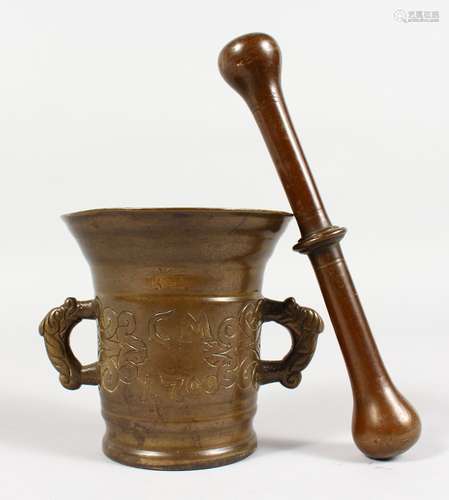 A CAST BRONZE TWIN-HANDLE PESTLE AND MORTAR, with engraved decoration, initialled CM, dated 1700.