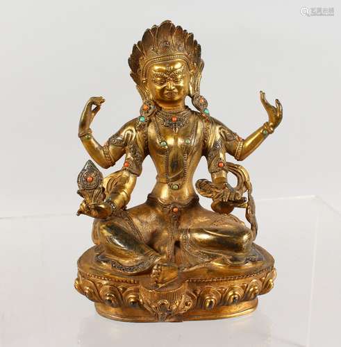 A CHINESE GILT BRONZE MULTI-ARM SEATED DEITY, inset with turquoise and coral. 7.5ins high.