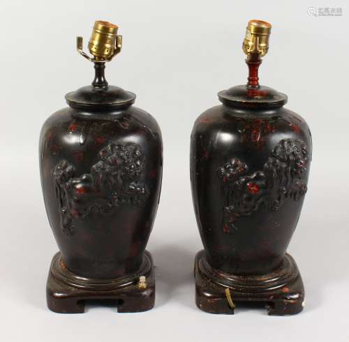 A PAIR OF CHINESE BRONZE TABLE LAMPS, each decorated with a Dog of Fo. 15ins high.