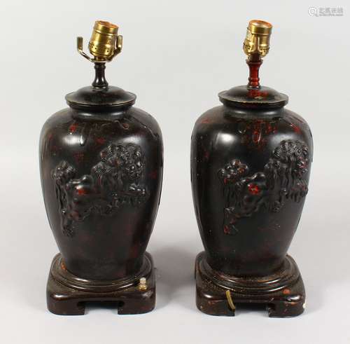 A PAIR OF CHINESE BRONZE TABLE LAMPS, each decorated with a Dog of Fo. 15ins high.