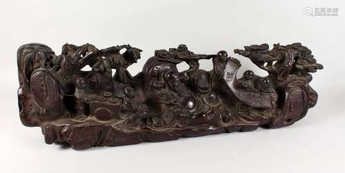 A LARGE CHINESE CARVED WOOD GROUP OF FIGURES AND TREES. 31ins long.