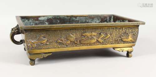 A CHINESE BRONZE RECTANGULAR CENSER, with mask handles, on scrolling feet. 17ins wide.