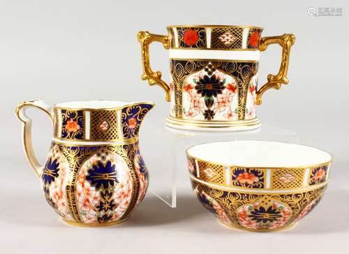 A ROYAL CROWN DERBY CREAM JUG AND SUGAR, painted with pattern 1128; together a with a matching two-