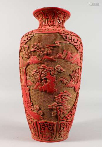 A LARGE CHINESE RED CINNABAR LACQUER VASE, incised with a mountainous landscape scene. 14.5ins