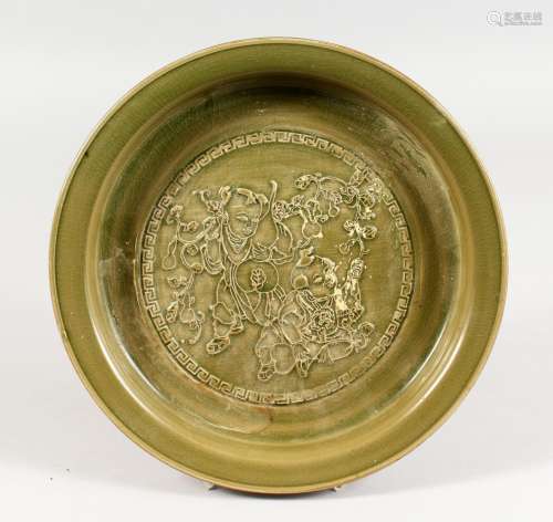 A CHINESE GREEN CELADON CIRCULAR BRUSH WASHER, with moulded decoration, on three feet. 10.5ins