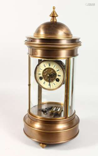 A LARGE CIRCULAR BRONZE CASED TABLE CLOCK, with enamel dial, eight-day movement, striking on a gong.