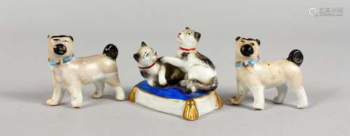 THREE SMALL CONTINENTAL PORCELAIN FIGURES OF DOGS. 2ins long.