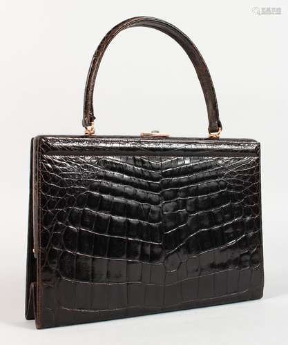 A BLACK CROCODILE SKIN HANDBAG, 10ins.