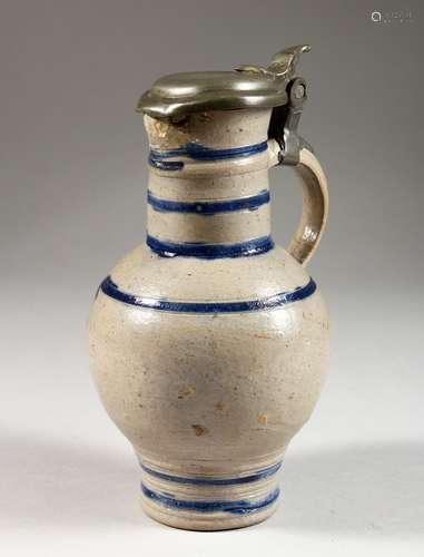 A FLEMISH SALT GLAZED POTTERY JUG, with pewter lid. 8ins high.