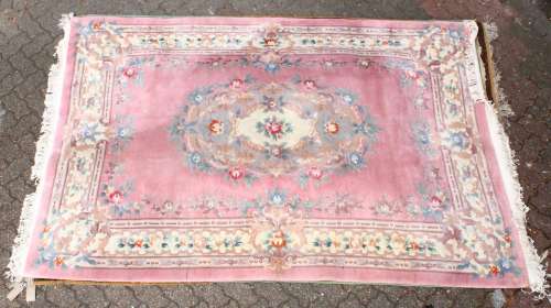 A 20TH CENTURY CHINESE CARPET, pink ground with floral decoration. 9ft 0ins x 6ft 0ins.