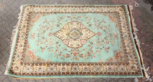 A 20TH CENTURY INDIAN CARPET, green ground with floral decoration. 8ft 10ins x 6ft 0ins.