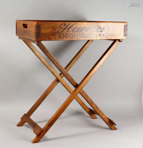 A NOVELTY HARDWOOD TRAY ON FOLDING STAND. Tray: 25.5ins long.