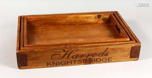 A GRADUATED SET OF THREE HARDWOOD TRAYS. Largest: 22ins long.