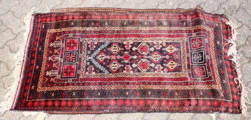 A SMALL 20TH CENTURY PERSIAN PRAYER RUG, black ground with stylised motifs. 5ft 0ins x 2ft 9ins.