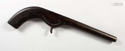 A FOLK ART CARVED WOOD MODEL OF A PISTOL. 15ins long.