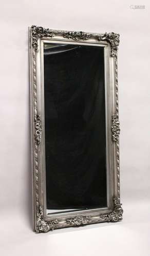 A LARGE WALL MIRROR, with moulded silver coloured frame. 5ft 7ins x 2ft 9ins.