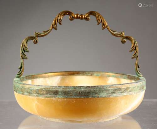 A CIRCULAR ONYX FRUIT BOWL, with metal mounts and handle. 7ins diameter.