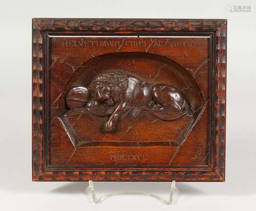 A RELIEF CARVED MAHOGANY PLAQUE OF A LION. 8.25ins wide.