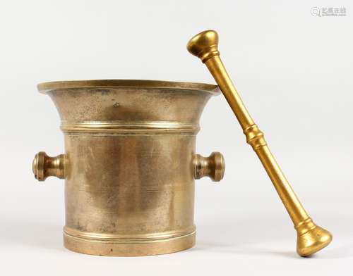 A LARGE POLISHED BRONZE PESTLE AND MORTAR. 8ins high.