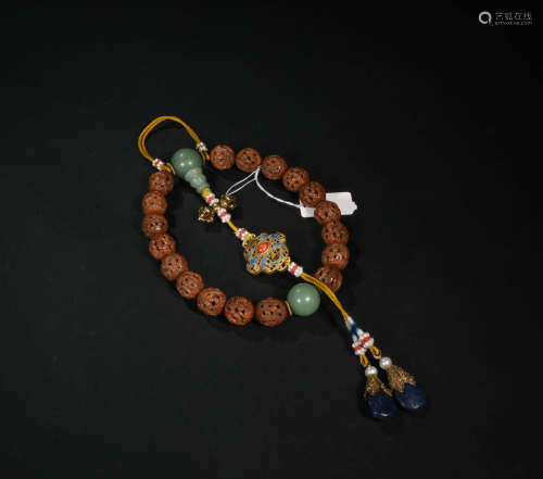 A Chinese Carved Nucleus Beads Hand String