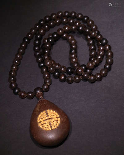 A CHENXIANG WOOD PENDANT EMBEDED WITH GOLD