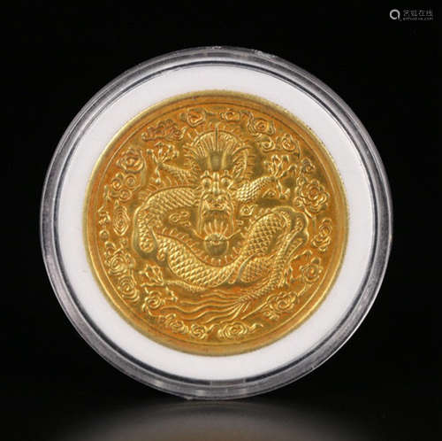 A GOLD COIN WITH DRAGON PATTERN