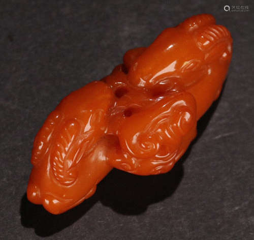 AN AMBER CARVED BEAST